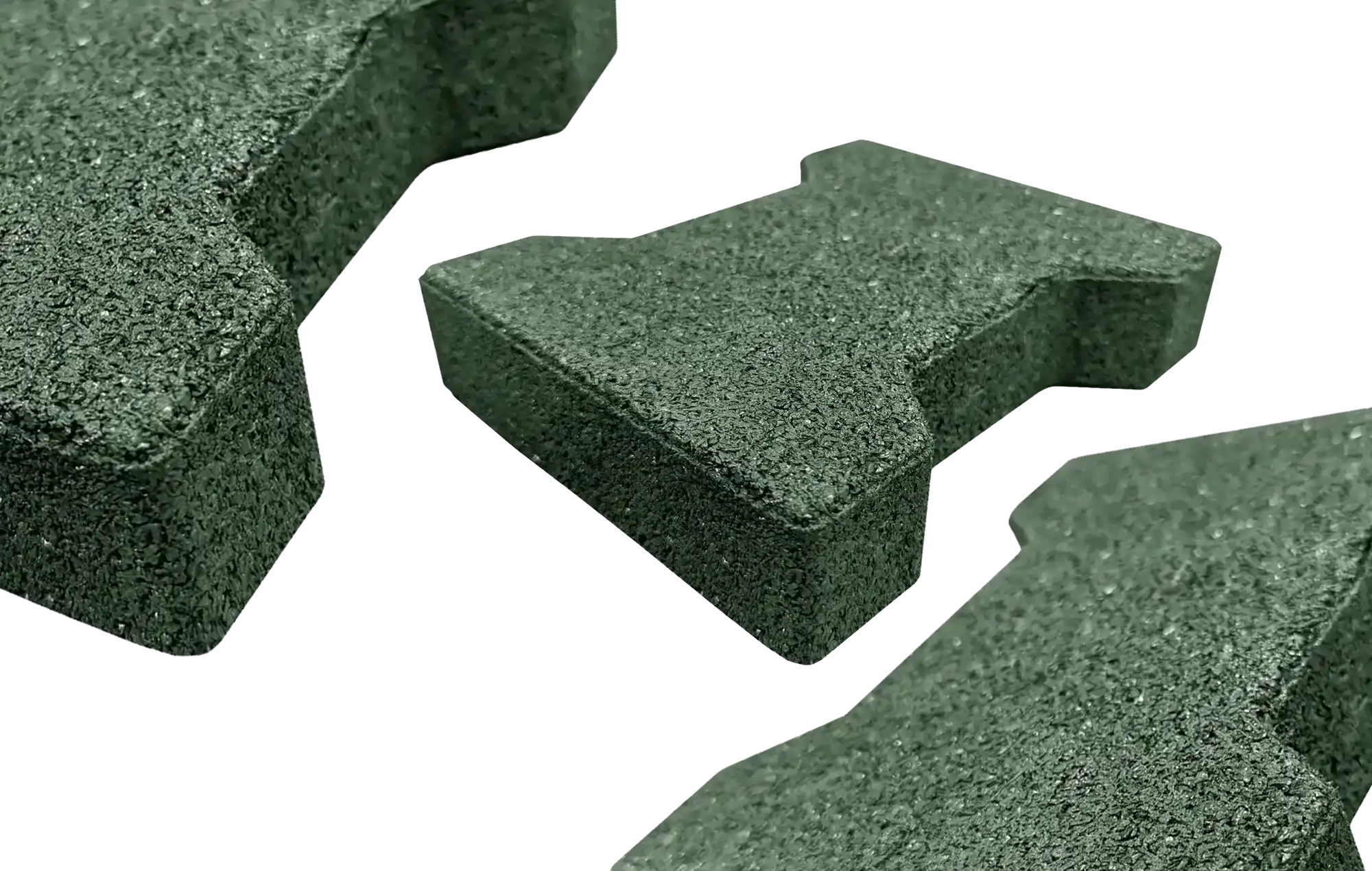 Three green rubber pavers with one centered and further away and two on the edges not fully in the frame and closer to the camera
