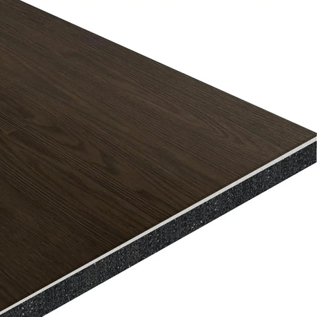 A close-up of ECORE Athletic's ECORE Baller Rally Laminate Roll - 14mm Class 2 Flooring shows its rectangular shape, dark wood grain finish, and a layered structure with a black core beneath the top laminate.