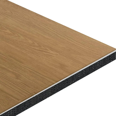 A close-up cross-section of the ECORE Baller Rally Laminate Roll - 14mm Class 2 Flooring by ECORE Athletic shows a wood-grain top layer, a thin white middle layer, and a thick black core underneath.