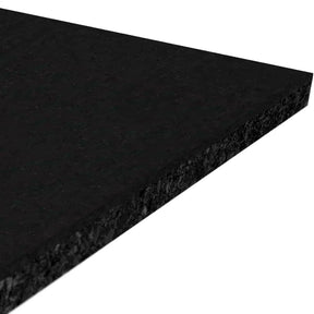 A close-up of the ECORE Performance Motivate Plus Rubber Roll - 10.5mm Flooring by ECORE Athletic shows its rectangular, black, textured rubber surface displayed at an angle against a white background.