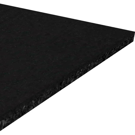 A close-up view of the corner of the ECORE Athletic Performance Beast Rubber Roll 10.5mm flooring, a flat, rectangular black sheet, photographed against a white background.