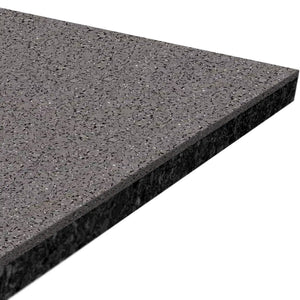 A close-up of ECORE Performance Beast Plus Rubber Roll - 14.5mm Flooring by ECORE Athletic showcases its polished, dark gray speckled surface and beveled edge.