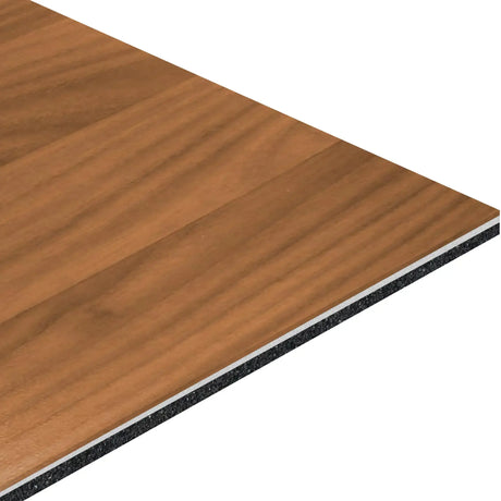 A close-up of the ECORE Athletic ECORE Bounce 2 Motivate Laminate Roll - 7mm Class 1 Flooring shows its rectangular shape, brown wood grain surface, and layered construction with a visible dark core.