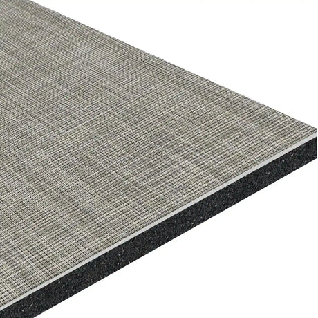 A close-up of the ECORE Ebb & Flow Motivate Laminate Roll - 6mm Class 1 Flooring by ECORE Athletic, featuring a rectangular sheet with a textured, grid-patterned surface and a solid dark base layer underneath.