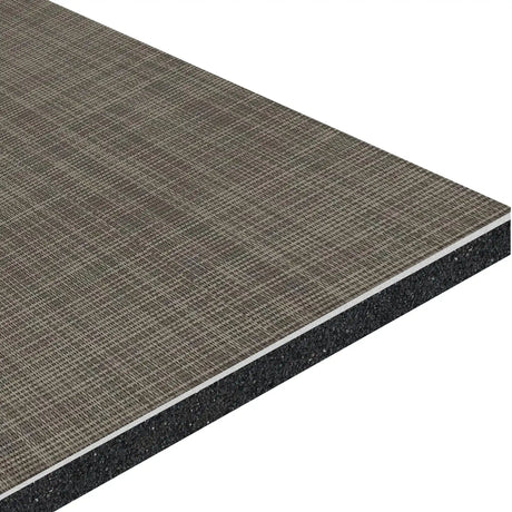 A close-up of the ECORE Ebb & Flow Motivate Laminate Roll - 6mm Class 1 Flooring by ECORE Athletic highlights its textured, grid-patterned brown surface over a dense underlayer, revealing the panel's layered construction.