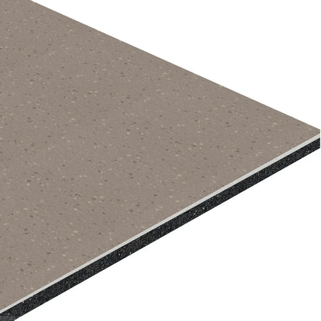 A close-up of the ECORE HydroGrip Motivate Laminate Roll - 7mm Class 1 Flooring by ECORE Athletic shows its rectangular, layered design with a speckled beige surface, thin white middle layer, and thick black bottom layer.