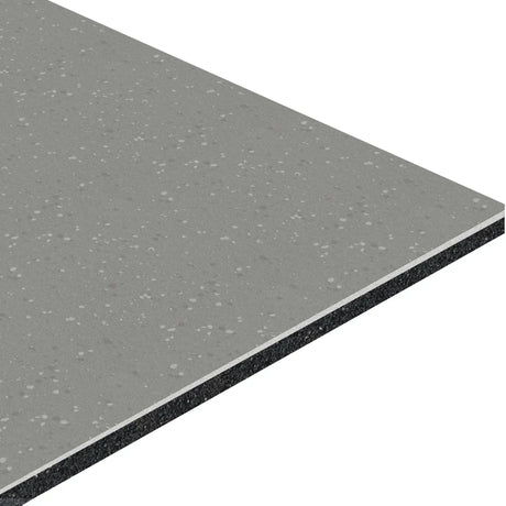 A close-up of the ECORE HydroGrip Motivate Laminate Roll - 7mm Class 1 Flooring by ECORE Athletic shows its rectangular sheet, gray speckled surface, and visible layered cross-section with a lighter gray top and darker core.