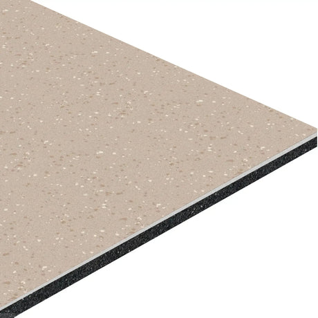 A close-up of the ECORE HydroGrip Motivate Laminate Roll - 7mm Class 1 Flooring by ECORE Athletic shows its rectangular beige speckled surface and visible layered cross-section with a light top layer and dark inner core.