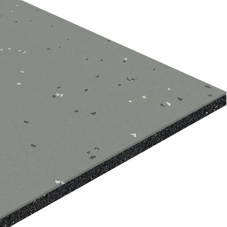 A close-up view of the ECORE Athletic Integrity Motivate Laminate Roll 7mm Class 1 Flooring shows its rectangular, gray speckled tile with a textured surface, featuring a layered structure with dark material in the middle and lighter gray on top.