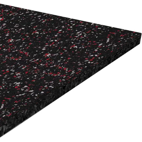 A close-up of the ECORE Athletic Performance Motivate Plus Rubber Roll - 10.5mm Flooring shows its rectangular black surface with red and gray speckles, highlighting its textured finish and substantial thickness.