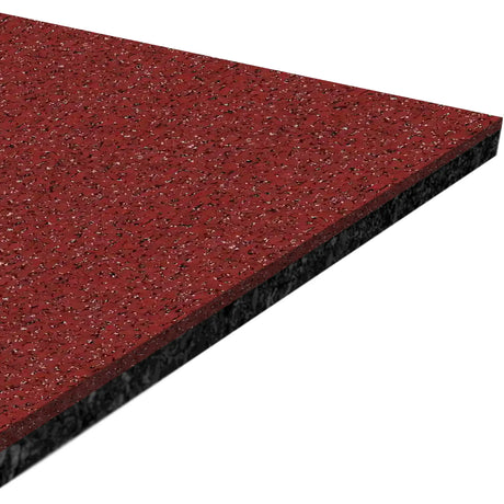 A close-up of the ECORE Athletic Performance Motivate Plus Rubber Roll - 10.5mm Flooring shows its rectangular red speckled surface with a black underside, viewed at an angle against a white background.