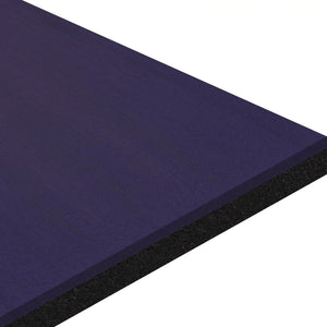 A close-up of the ECORE Moxie Beast Laminate Roll - 10.5mm Flooring by ECORE Athletic, featuring a smooth dark blue top and black textured underside, shown angled against a white background.