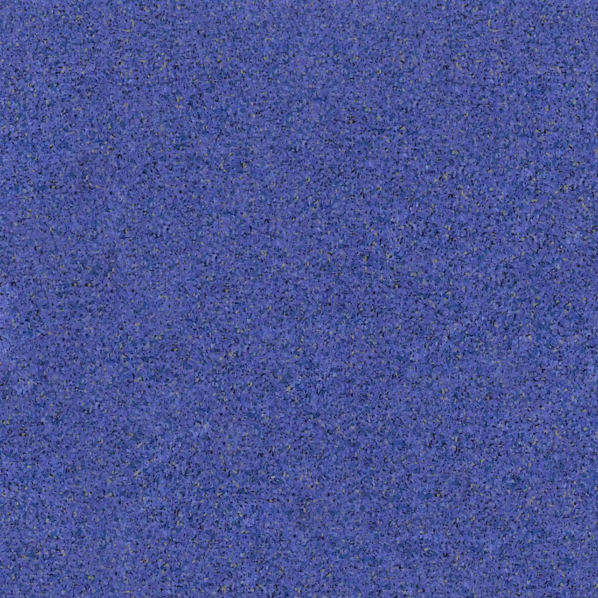 A close-up of the ECORE PlayGuard Rubber Tile - 2.5" Playground Flooring by ECORE Athletic shows a textured blue surface with grainy, speckled details in darker and lighter shades.