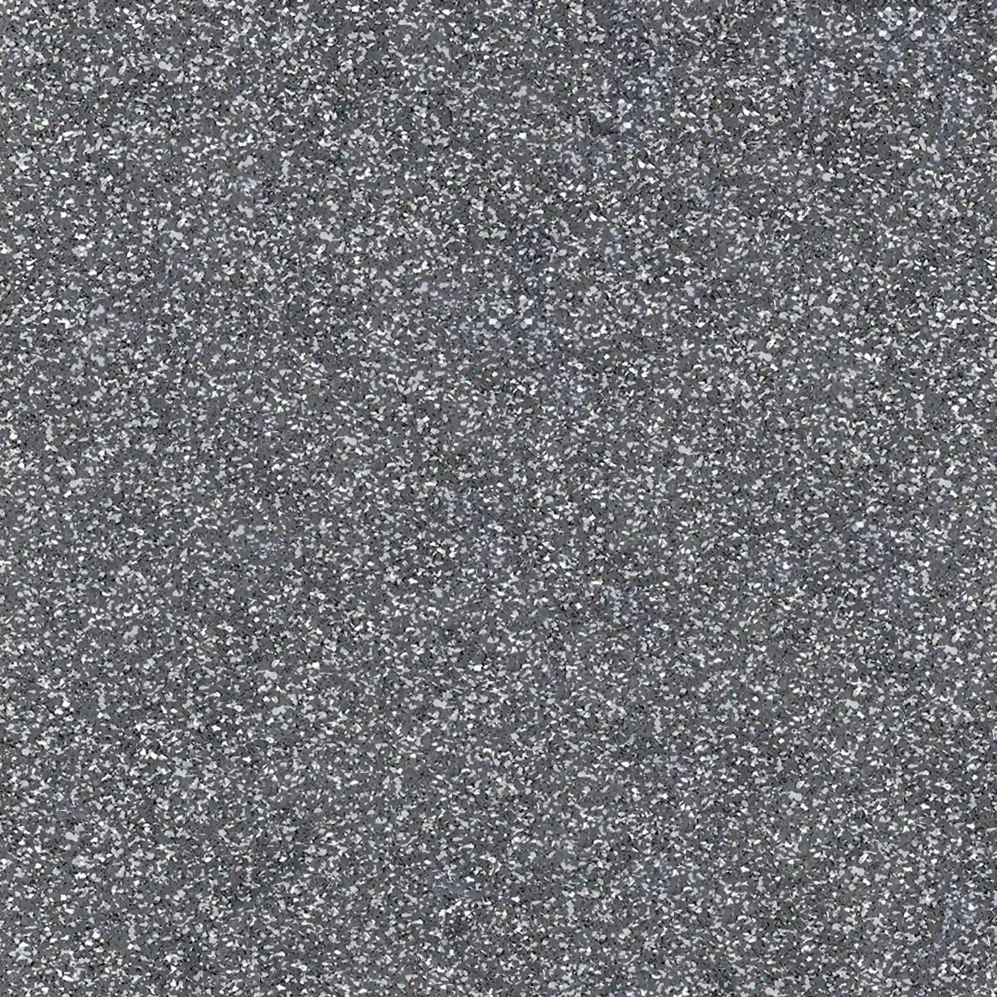 Close-up view of ECORE PlayGuard Rubber Tile - 2.5" Playground Flooring by ECORE Athletic, revealing its rough gray surface with light and dark specks that showcase the textured look of this durable playground flooring.