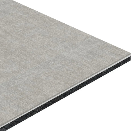 A close-up of the ECORE Athletic ECORE Restorative Motivate Laminate Roll - 7mm Class 1 Flooring shows its rectangular, gray, layered panel with a textured top and dark core, angled against a white background.