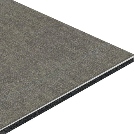 A close-up of the ECORE Athletic Restorative Motivate Laminate Roll - 7mm Class 1 Flooring shows its rectangular, textured gray surface and layered cross-section with a thin white core between gray top and darker bottom layers.