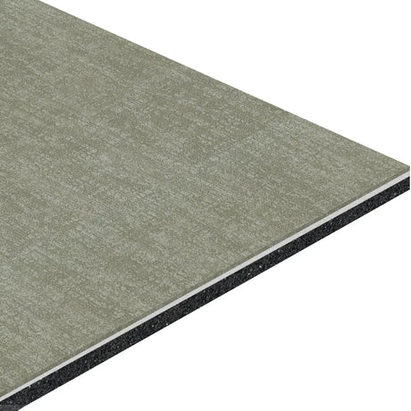 A close-up of an angled ECORE Restorative Motivate Laminate Roll - 7mm Class 1 Flooring by ECORE Athletic, featuring a textured light gray surface and black edge, resembling high-quality composite building material.