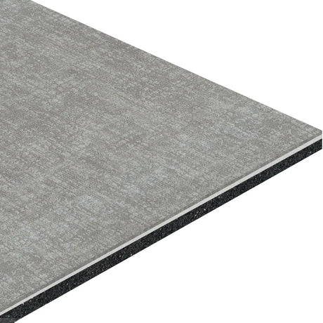 A close-up view of ECORE Athletic’s ECORE Restorative Motivate Laminate Roll - 7mm Class 1 Flooring shows its grey, textured surface, layered construction, visible thickness, and clean, straight edges.