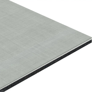 A close-up of the ECORE Serenity Motivate Laminate Roll - 7mm Class 1 Flooring by ECORE Athletic shows its rectangular, layered structure with a textured light gray surface and dark inner core, emphasizing its thickness.