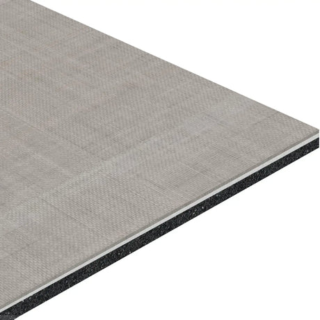 A close-up of the ECORE Athletic ECORE Serenity Motivate Laminate Roll - 7mm Class 1 Flooring shows its rectangular, gray composite panel with a textured surface, visible layers, and thickness revealing its multi-material construction.
