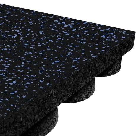 Close-up of the ECORE Athletic ECORE Performance UltraTile - 1" Rubber Tile, featuring black rubber with blue speckles and a textured underside with evenly spaced raised circular supports for enhanced cushioning and stability.