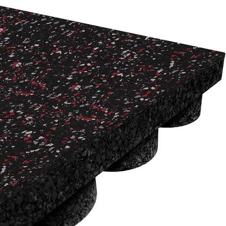 Close-up of the ECORE Performance UltraTile - 1" Rubber Tile by ECORE Athletic, featuring thick black rubber with red and gray speckles and an interlocking underside with circular grooves for shock absorption.