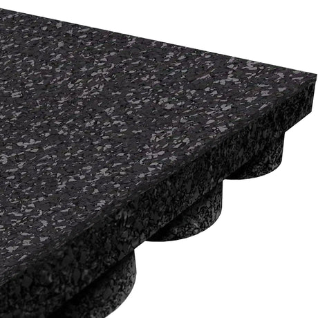 Close-up of an ECORE Athletic Performance UltraTile 1" rubber tile in black, with speckled surface and interlocking round supports underneath for shock absorption and stability.
