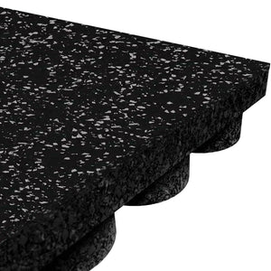 Close-up of the ECORE Performance UltraTile - 1" Rubber Tile by ECORE Athletic, featuring thick black rubber with white speckles, a textured top surface, and a bottom layer with raised circular support nubs.