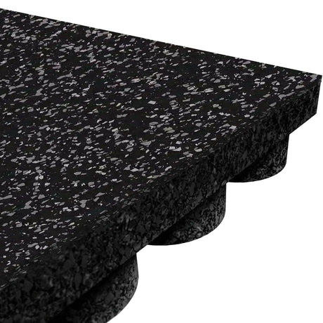 Close-up of the ECORE Performance UltraTile - 1" Rubber Tile by ECORE Athletic, featuring a thick black rubber surface with small gray speckles and an underside designed with evenly spaced round protrusions for cushioning and support.