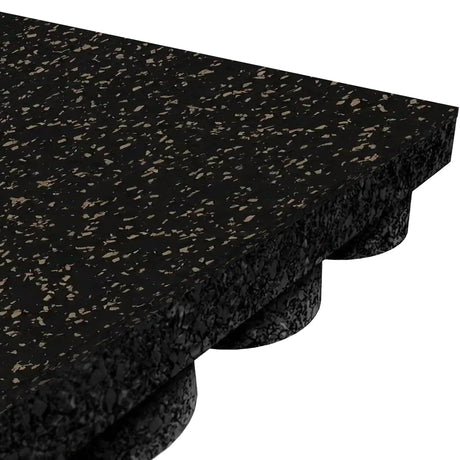A close-up of the ECORE Athletic ECORE Performance UltraTile - 1" Rubber Tile shows its black rubber design with brown speckles, textured surface, and a bottom side featuring raised, rounded supports for cushioning and shock absorption.