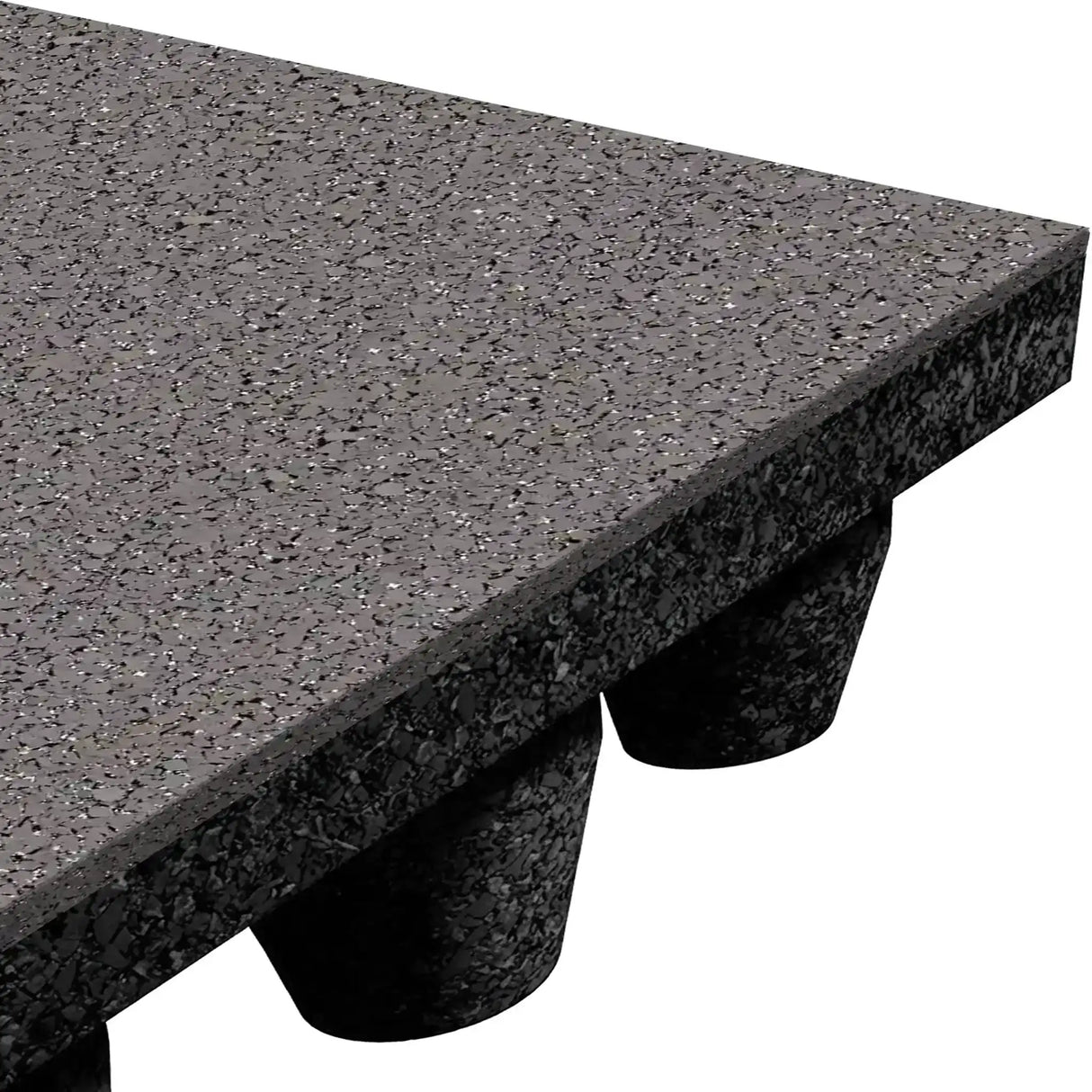 A close-up of the ECORE Athletic ECORE Performance dBTile Rubber Tile - 2.5" Acoustic Flooring shows its textured, speckled black surface, thick edge, and multiple raised cylindrical supports on the underside.