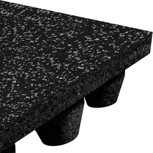 Close-up of the ECORE Performance dBTile Rubber Tile - 2.5" Acoustic Flooring by ECORE Athletic, showing the thick black tile with grey flecks, textured surface, and underside with raised cylindrical supports.