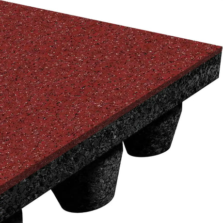 A close-up of the ECORE Performance dBTile Rubber Tile by ECORE Athletic, a 2.5" thick, red acoustic flooring tile with a speckled surface and black underside featuring cylindrical support pedestals.