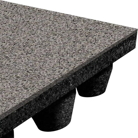Close-up of an ECORE Performance dBTile Rubber Tile - 2.5" Acoustic Flooring by ECORE Athletic, featuring a speckled gray textured surface and supported by black, rounded cone-shaped feet. Image highlights the panel's corner at an angle.