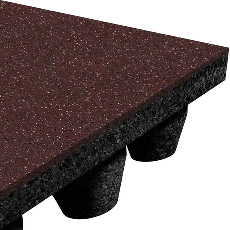 Close-up of an ECORE Performance dBTile Rubber Tile - 2.5" Acoustic Flooring from ECORE Athletic, showing a thick, rectangular, reddish-brown tile with a speckled top and textured black underside with cylindrical supports on a white background.