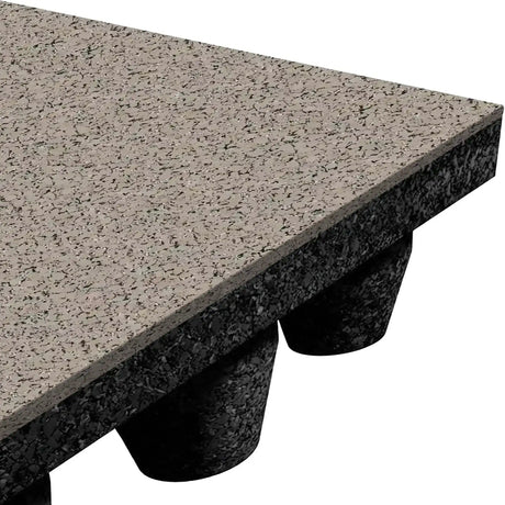 Close-up of the ECORE Athletic ECORE Performance dBTile Rubber Tile - 2.5" Acoustic Flooring shows its gray, speckled textured surface and black rounded rubber supports beneath, highlighting the mat's thickness and support structure.