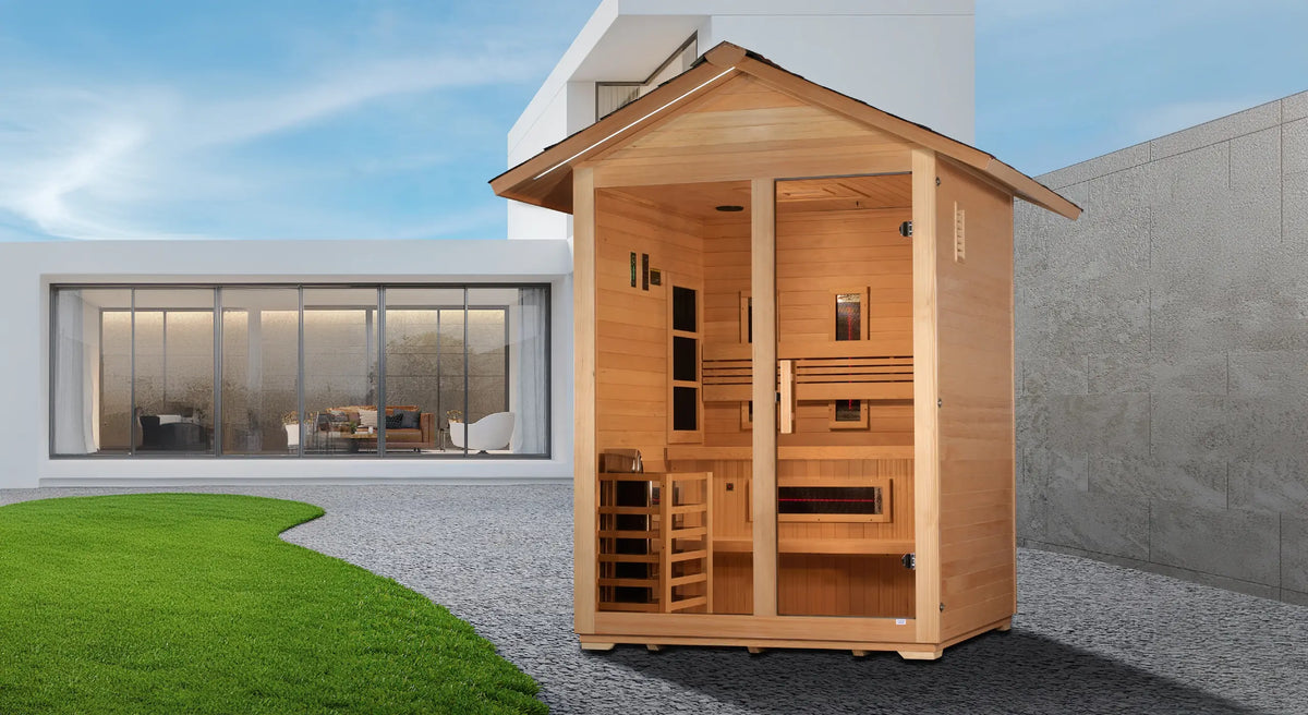 Golden Designs Carinthia model hybrid full spectrum infrared traditional steam sauna built for outdoor use with a 3 person capacity and a gabled roof which is constructed from Canadian hemlock wood in the back yard of a modern mansion