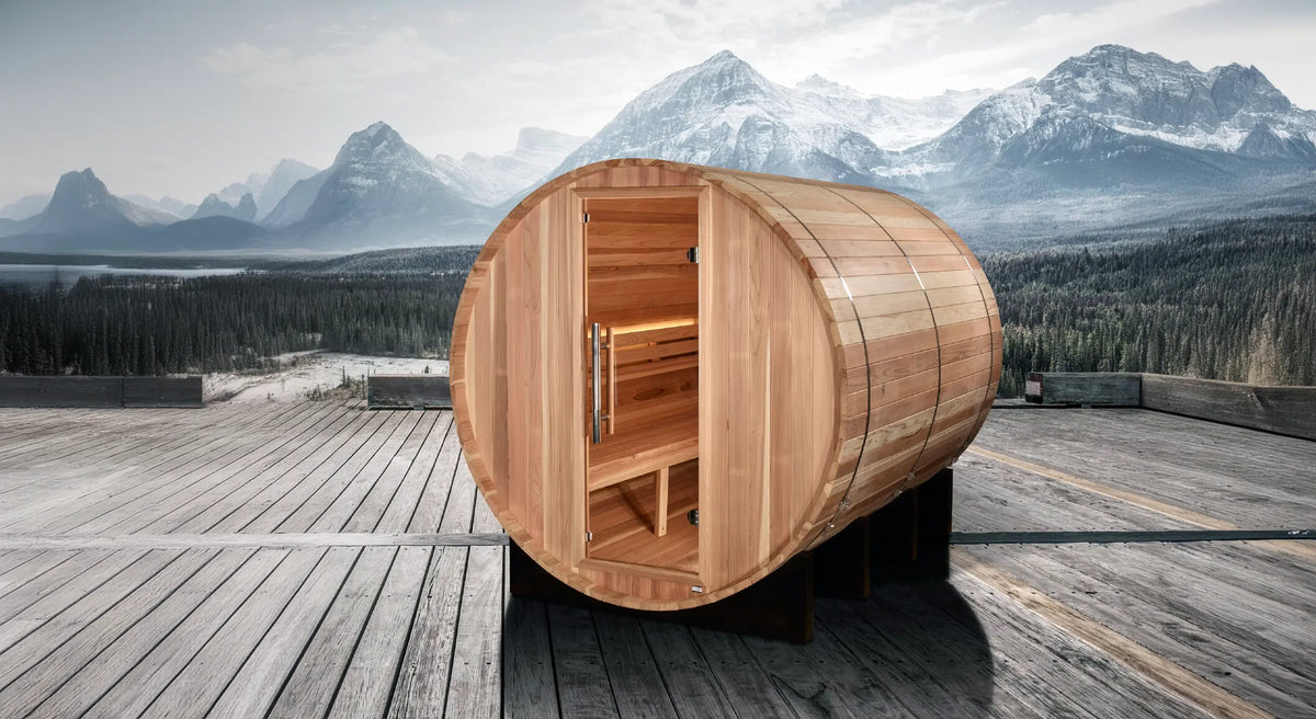 Golden Designs Klosters model barrel shaped sauna with a 6 person capacity which is built for outside use on a deck overlooking the mountains