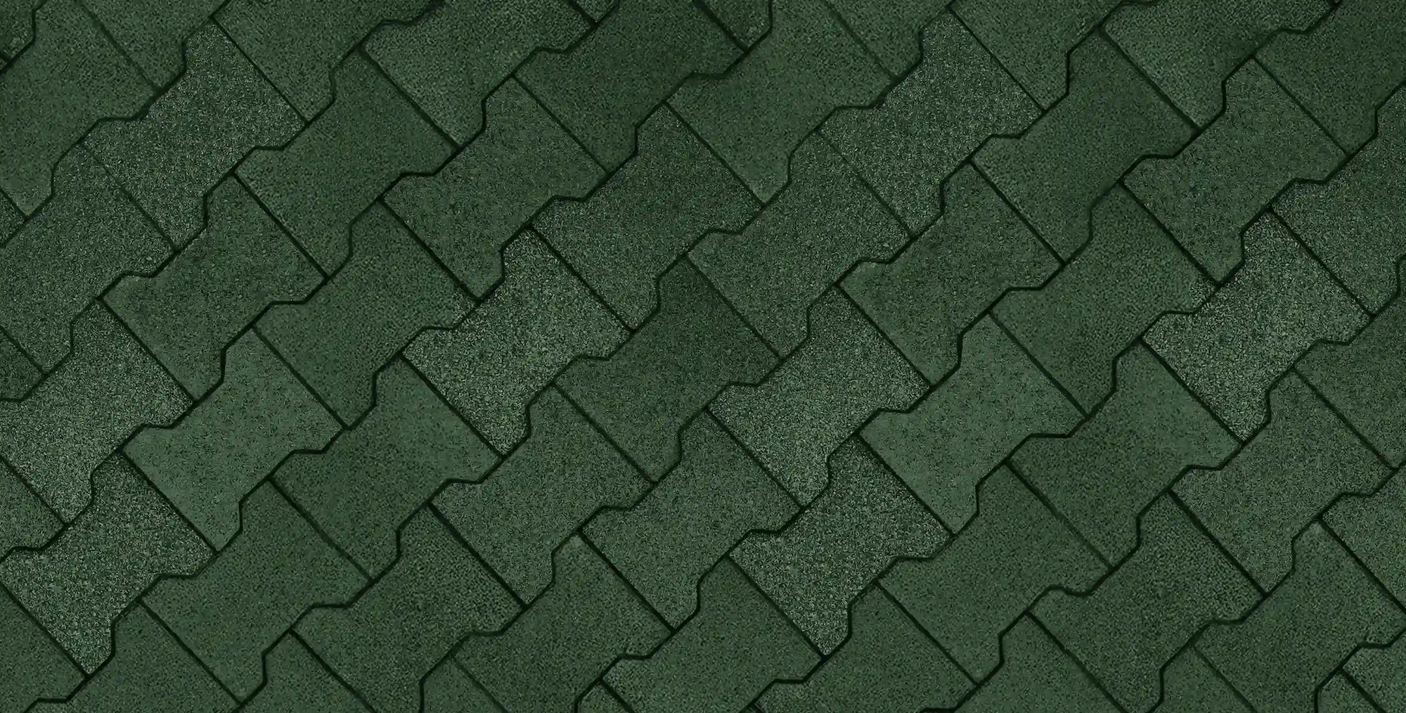 An overhead top-down view of a floor made from green rubber pavers in an interlocking pattern