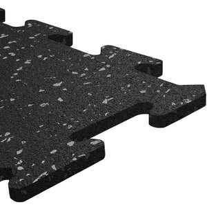 Close-up of an ECORE Rubber Floor Tile - 8mm Interlocking by ECORE Athletic, featuring a black, textured surface with white and gray speckles and puzzle-like edges, displayed on a white background.