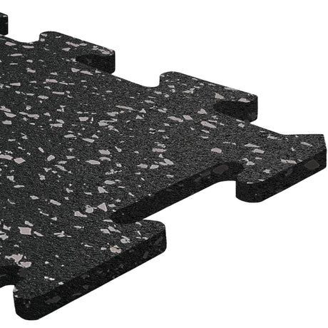 A close-up of an ECORE Athletic ECORE Rubber Floor Tiles - 8mm Interlocking tile, featuring a black surface with gray speckles, textured finish, and puzzle-like connecting edges.