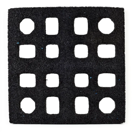 The ECORE Quad Blok Connector for 2.5" Tiles by ECORE Athletic is a black square mat featuring a 4x4 grid of evenly spaced, square cutouts with slightly rounded corners and a rough, textured surface.