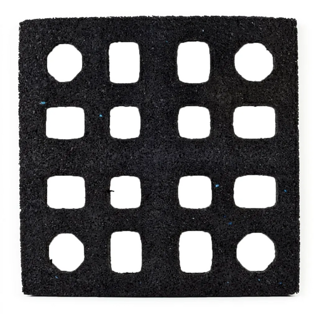 The ECORE Quad Blok Connector for 2.5" Tiles by ECORE Athletic is a black square mat featuring a 4x4 grid of evenly spaced, square cutouts with slightly rounded corners and a rough, textured surface.