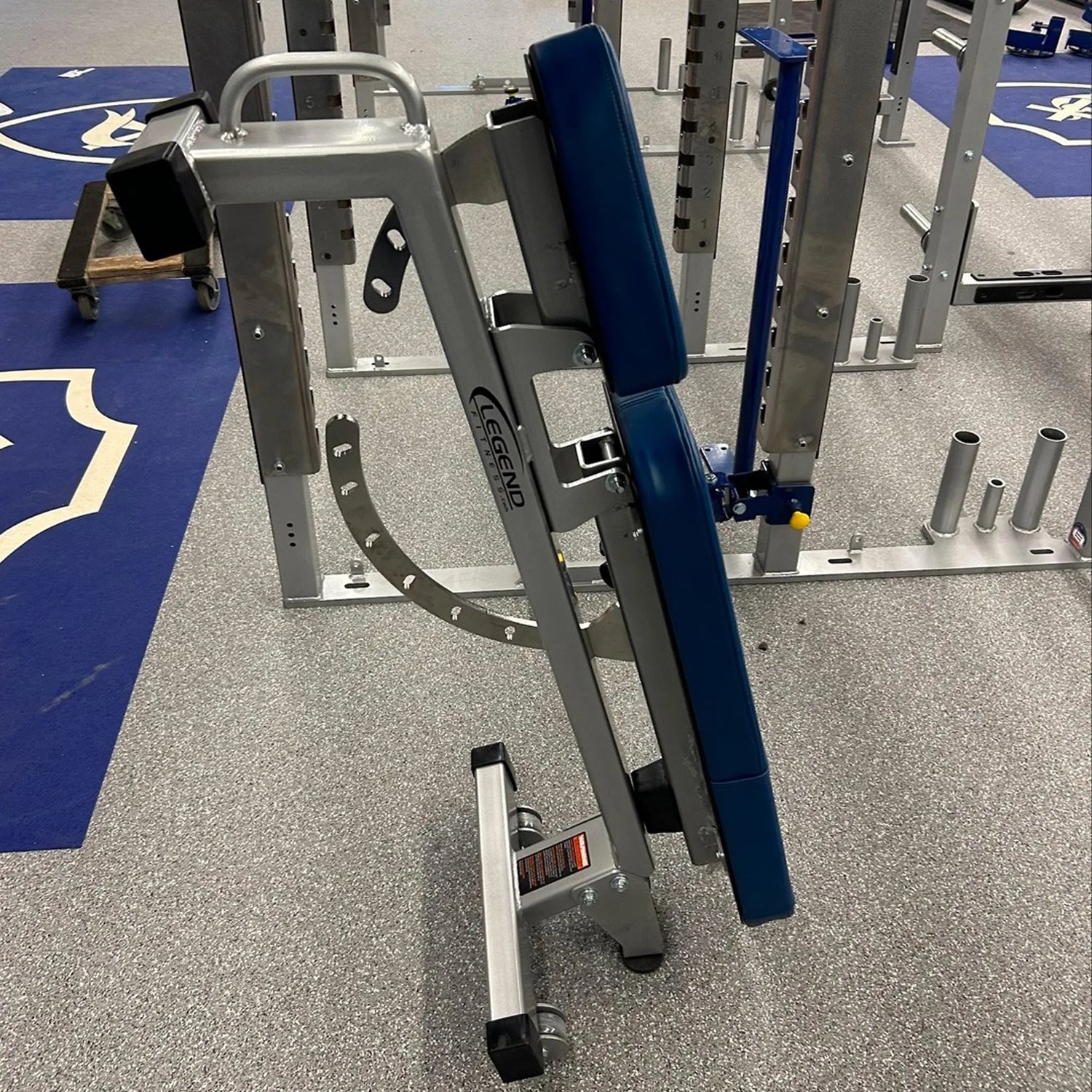 Gym equipment with blue padding on a gray floor