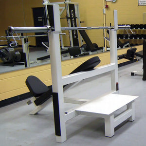 Gym equipment including a weight bench and barbell rack in a fitness center.