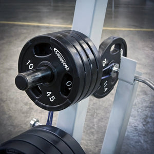 Barbell with weight plates on a rack in a gym setting
