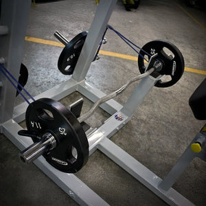 Weightlifting machine with weight plates on a concrete floor