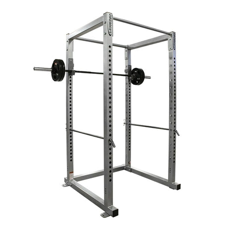 Gray power rack with barbell on a white background