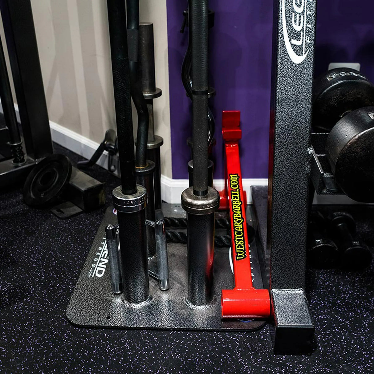 Close up image of a black and silver barbell holder full of barbells on a gym floor