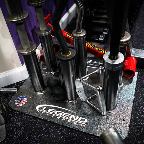 Close up image of a black and silver barbell holder full of barbells on a gym floor